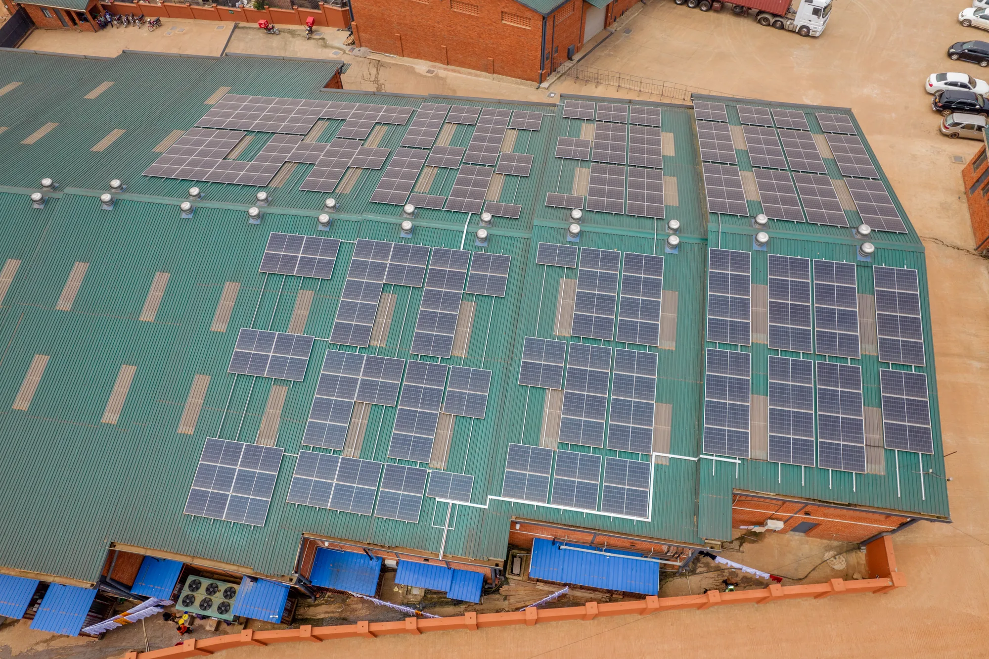 Aerial view of a grid-tied rooftop solar system on a livestock facility in Uganda